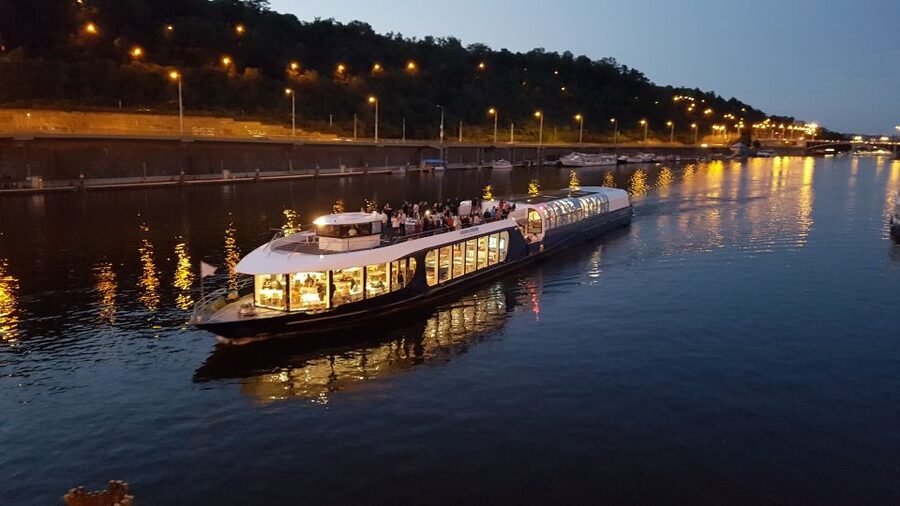 Prague: City Tour and Dinner Cruise with Hotel Pickup - Boarding the Vltava boat for a three-hour evening