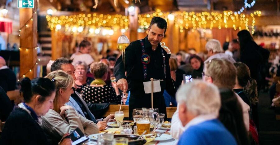 Prague: Evening Folklore Garden Party with Traditional Menu - A Czech garden party with a stage and a long shared table
