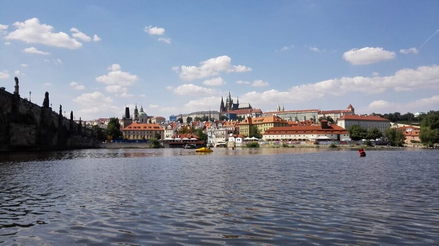 Prague: Old Town Guided Walking Tour and City Boat Ride - Arriving at Charles Bridge and changing pace