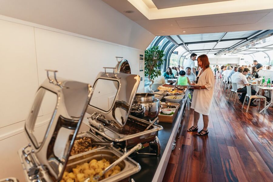 Prague: Sightseeing Dinner Cruise on Open-Top Glass Boat - Seating, windows, and the open deck