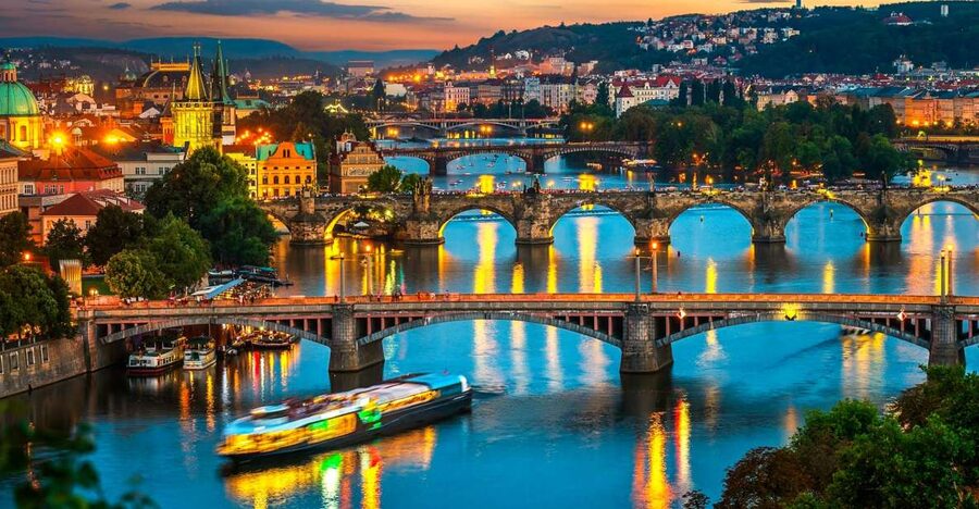 The Vltava bridges at dusk with Prague Castle on the skyline